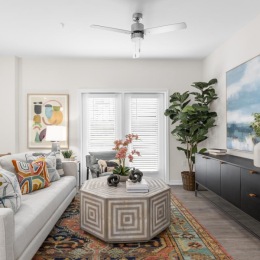 a living room with a fan and couches