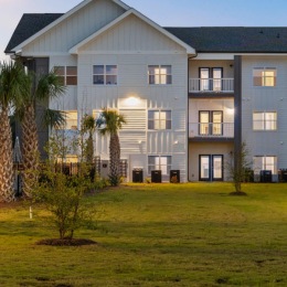 a building with palm trees in front