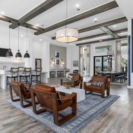 a large room with a wood floor and a wood floor with a table and chairs and a rug