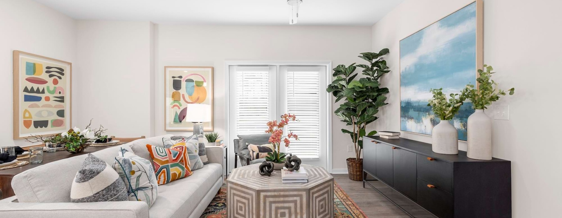 a living room with a fan and couches